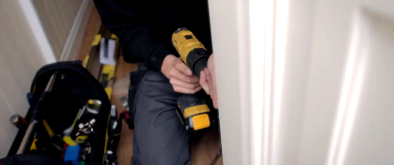SecureKey Pros residential locksmith cutting and fitting a new door key in Federal Way, WA